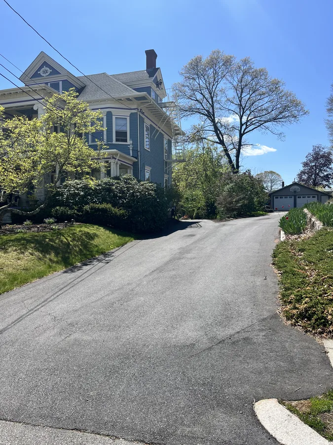Cracked driveway showing UV fade and wear