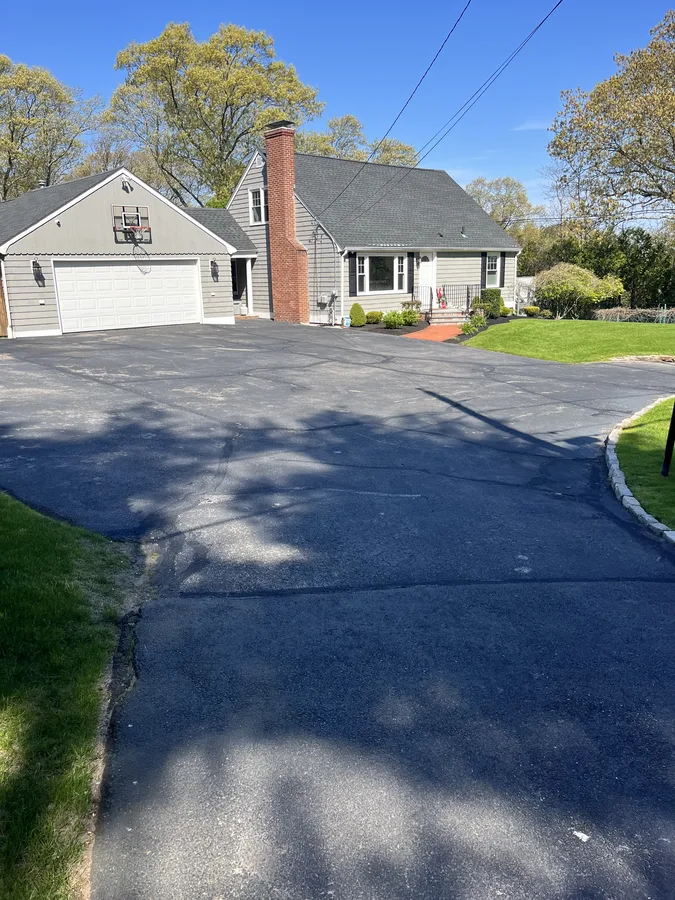 Deteriorated asphalt with edge cracking before sealcoating