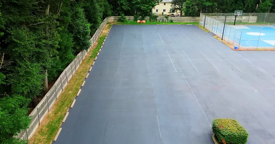 Faded barely-visible parking lot striping