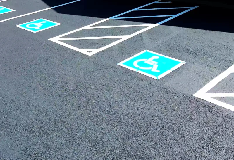 ADA van-accessible space with freshly painted handicap symbol and access aisle