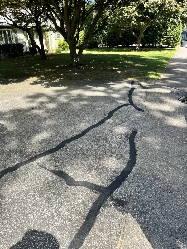 Crack sealed flush with hot rubberized filler